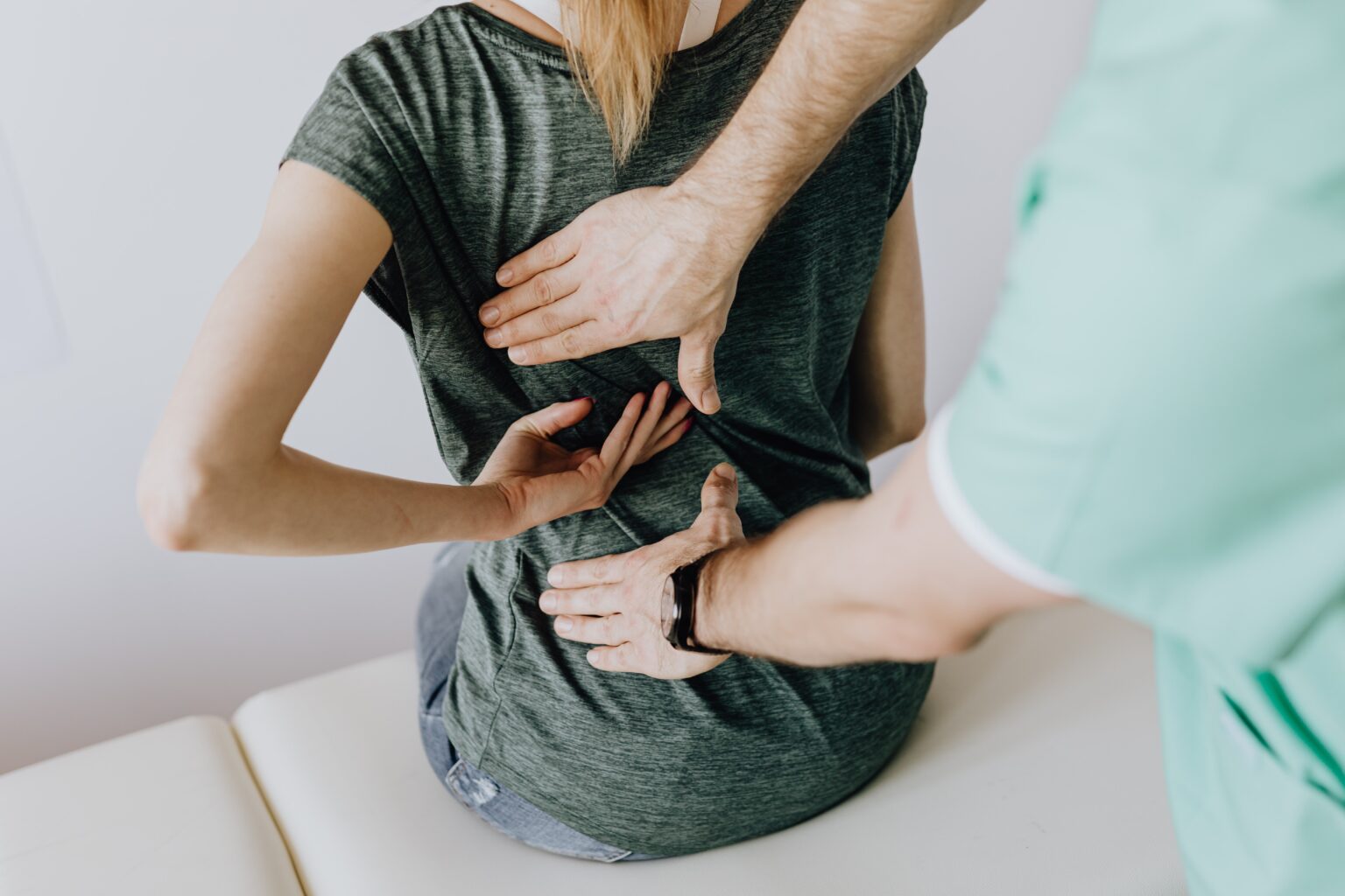 Doctor Examining A Patient's Back For Chronic Pain