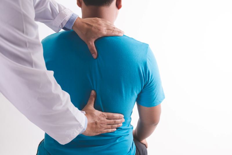 Doctor Examining Patient For Back Pain in Tamarac, FL