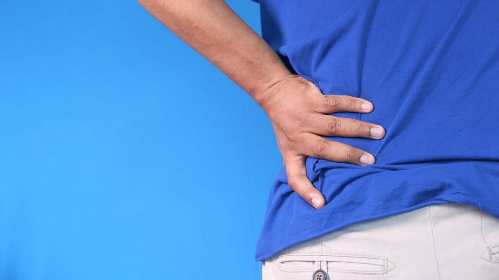 A Person Holding His Back in Pain