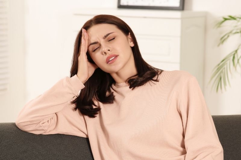 Woman Touching Head in Distress